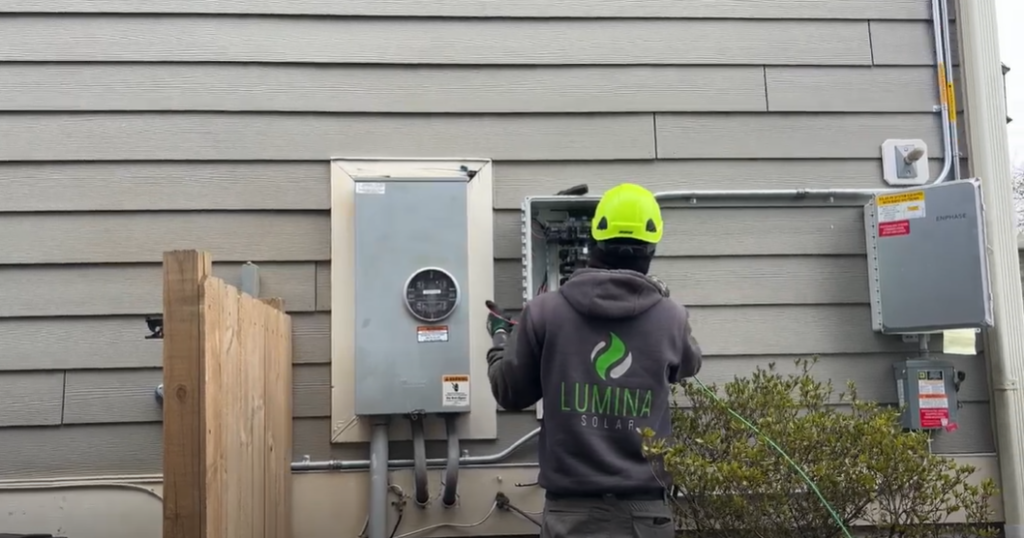 Lumina Solar electrician performing electrical services on the side of a home