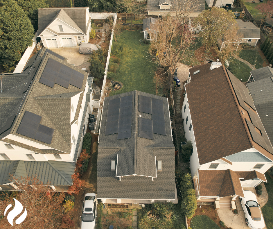 aerial view of 3 homes with solar arrays on the roofs