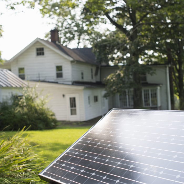 A solar panel in a farmhouse garden.